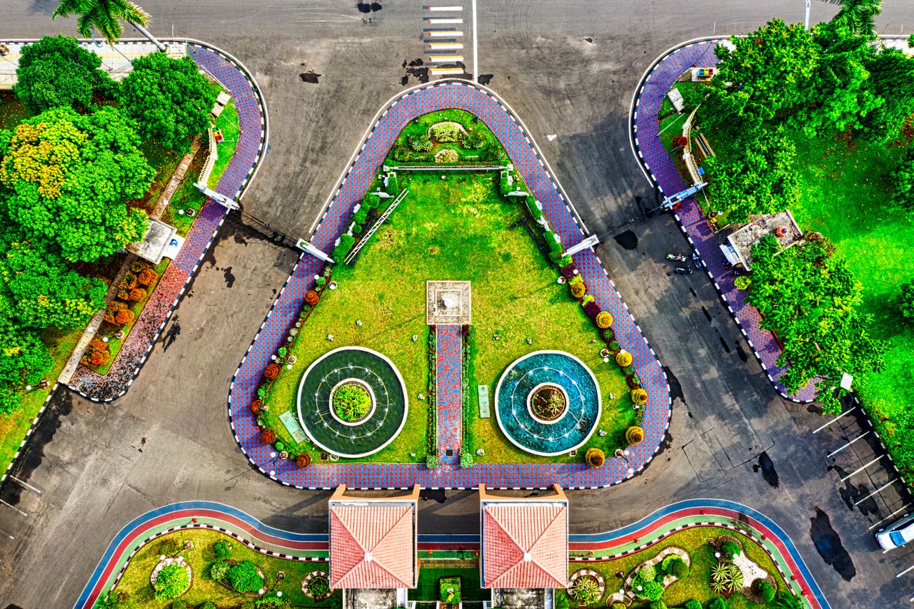 A vibrant aerial view of a geometric urban park in Tangerang, Indonesia, featuring lush greenery and modern design.